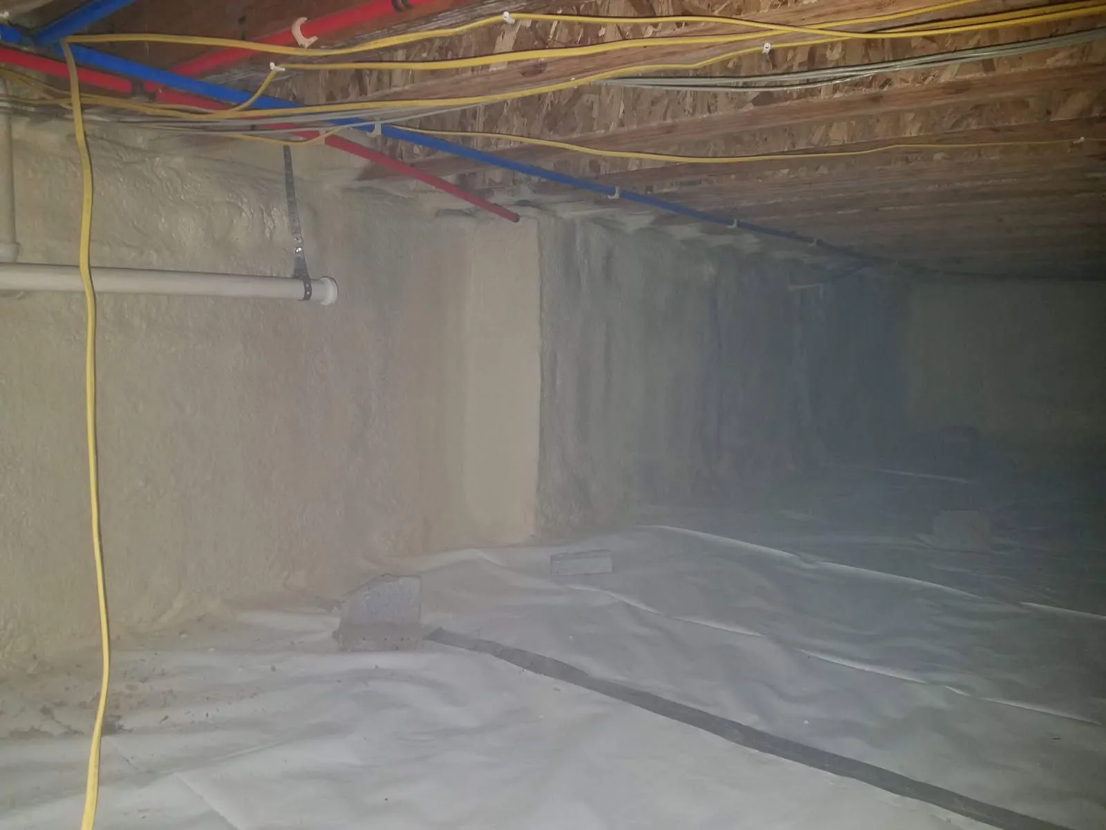 Finished crawl space encapsulation with vapor barrier and overhead water lines