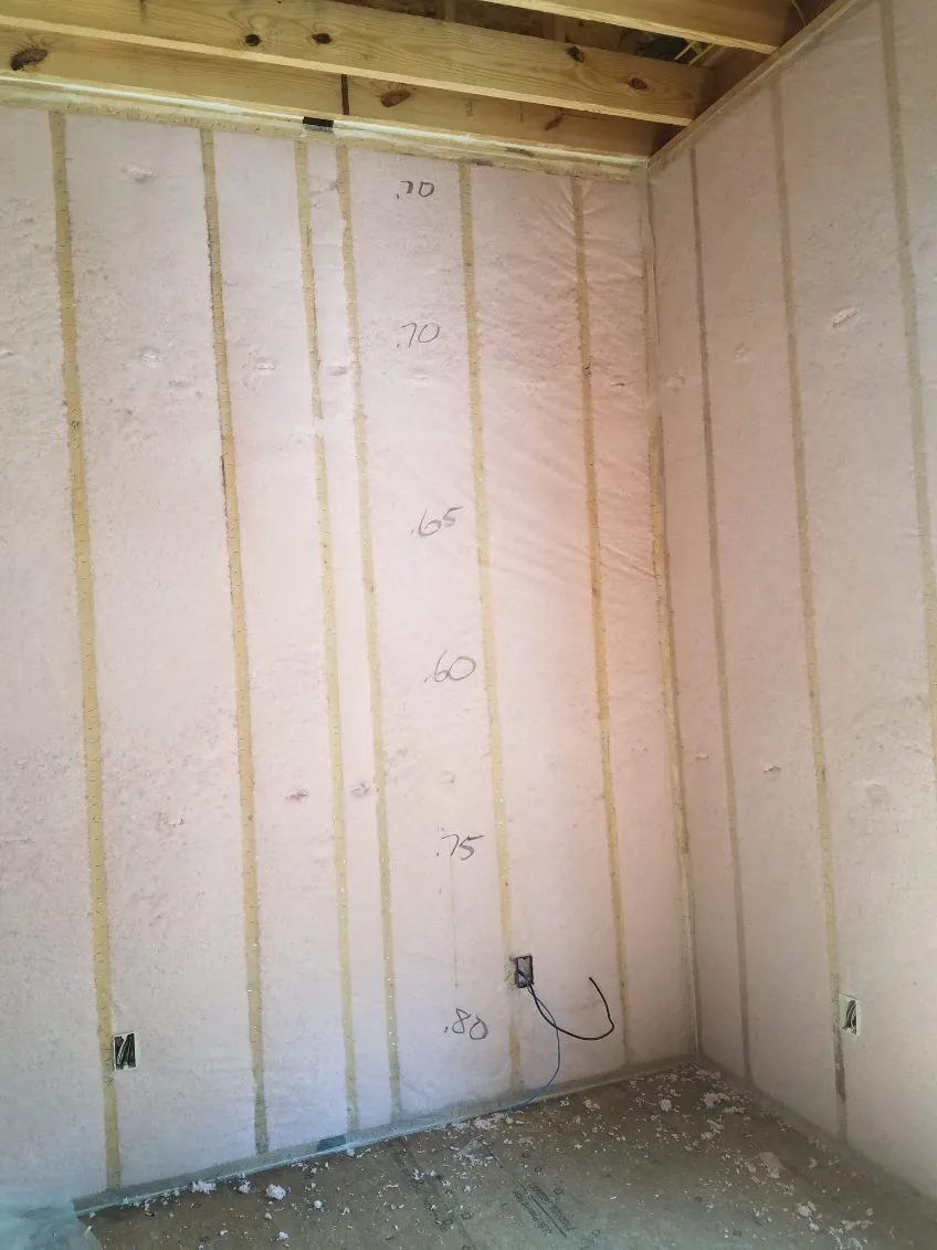 Blown-in blanket wall insulation in a framed room ready for drywall