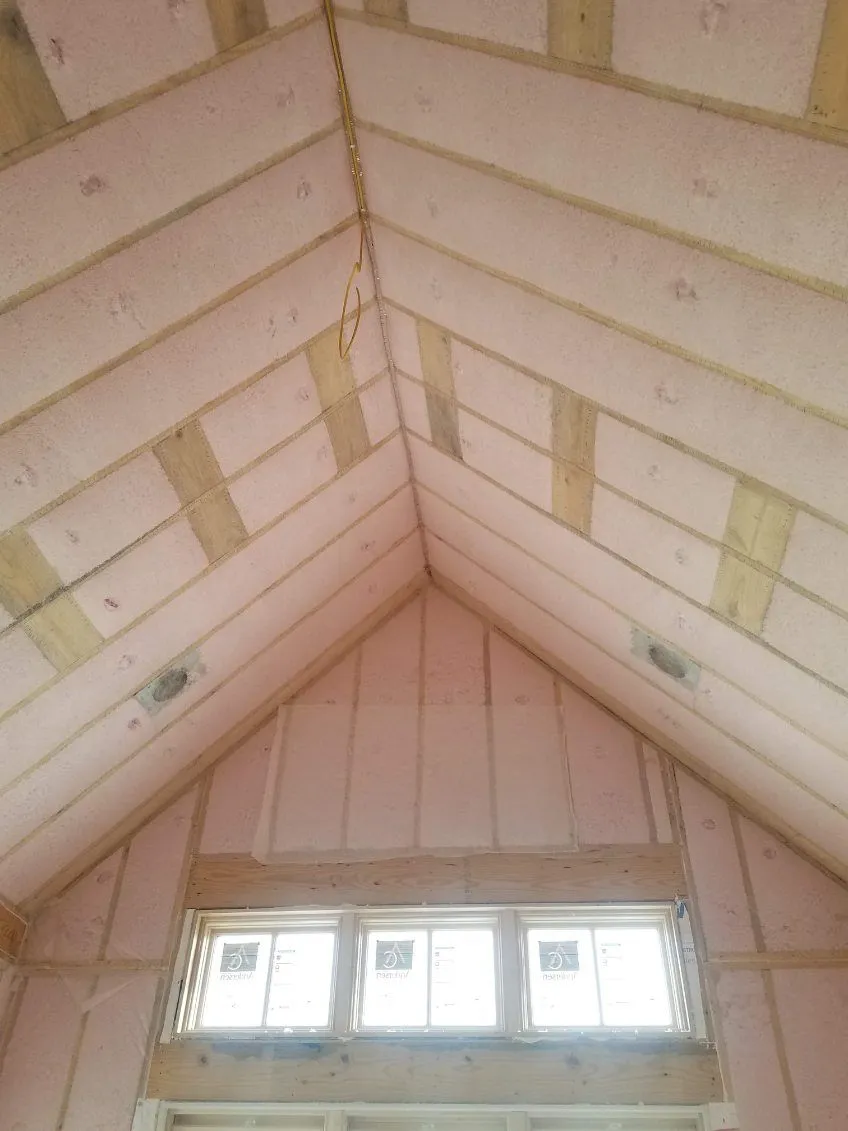 Insulated vaulted ceiling above a framed window opening