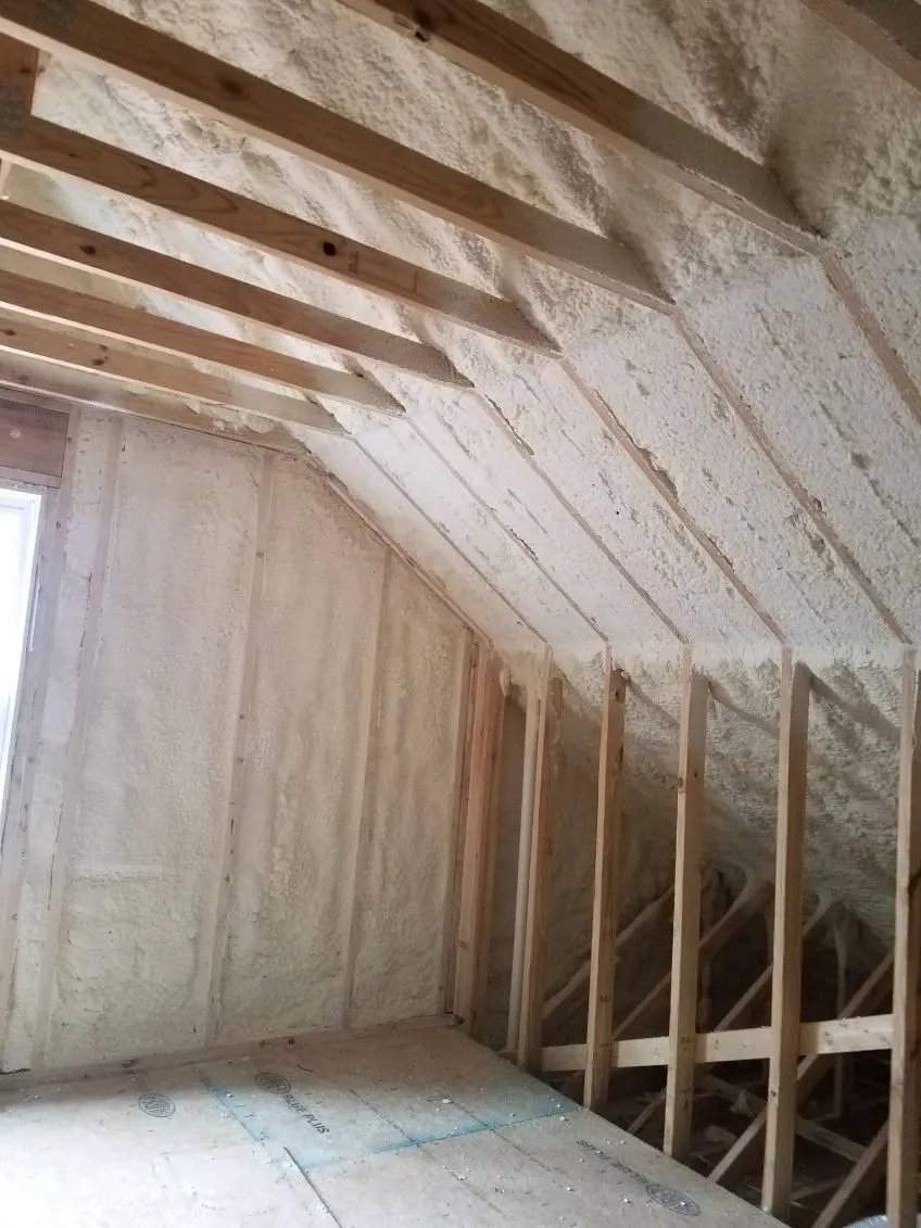 Spray foam insulation on the sloped ceiling and knee wall of an attic space
